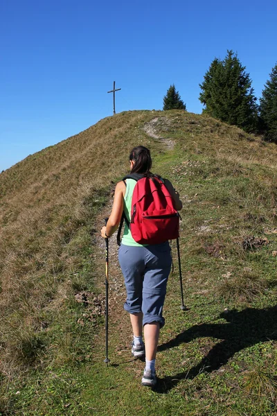 Mountaineering woman and mountain cross — Stock Photo, Image