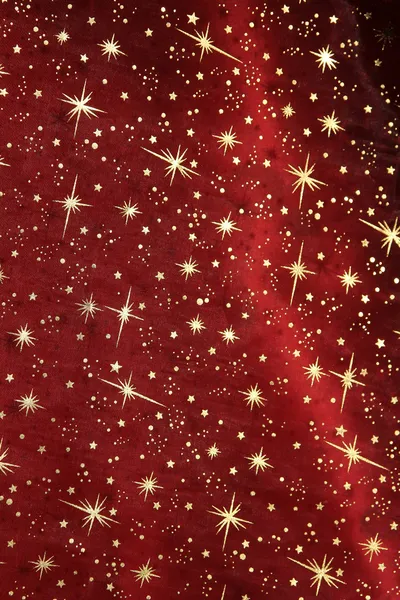 Drappeggio di raso rosso con scintillanti stelle d'oro — Foto Stock