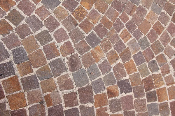 Curved pavement of colorful red granite blocks — Stock Photo, Image