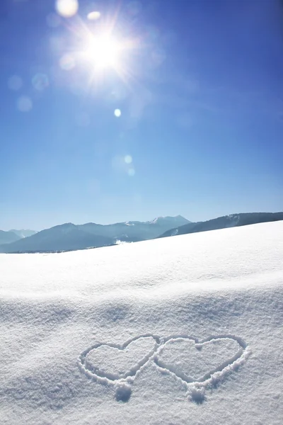 Wintry bavarian landscape with love hearts and bright sunshine with flares — Stock Photo, Image