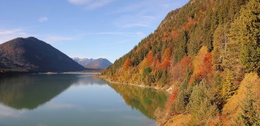artificial lake sylvenstein in autumn colors, bavarian landscape clipart