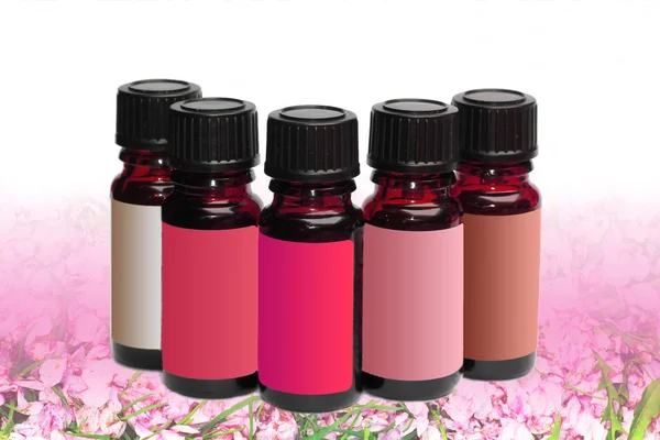 Five phials unlabeled on cherry blossom background — Stock Photo, Image