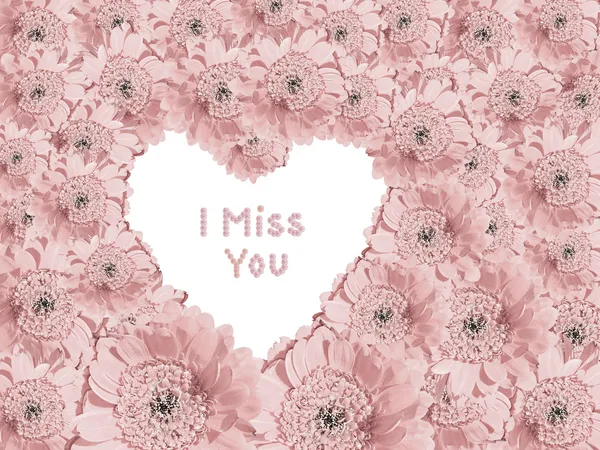 Light pink gerber daisies with heart shaped copy space and text — Stock Photo, Image