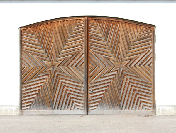 Wooden garage door with star-shaped carving — Stock Photo, Image