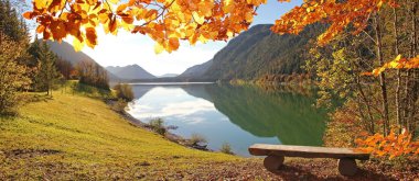 idyllic autumnal scenery lake sylvenstein, germany clipart