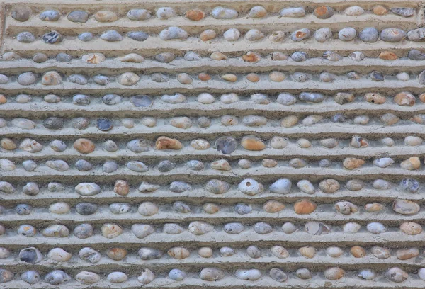 Wall with embedded pebble stones — Stock Photo, Image
