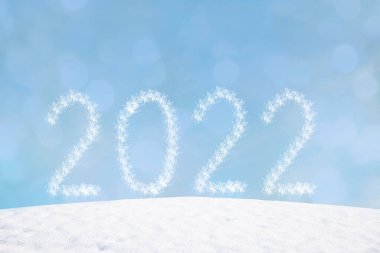 wintry background with flares and snowy hill. new years background 2022.