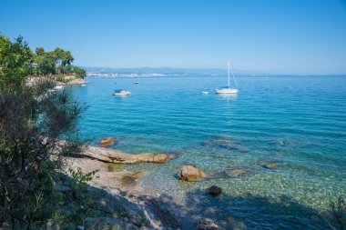 bathing beach Kvarner Bucht near Opatija, croatia. blue ocean with boats, coastal landscape