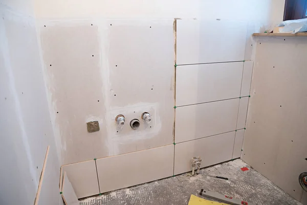 home renovation. lay new wall tiles on plasterboard in the guest toilet