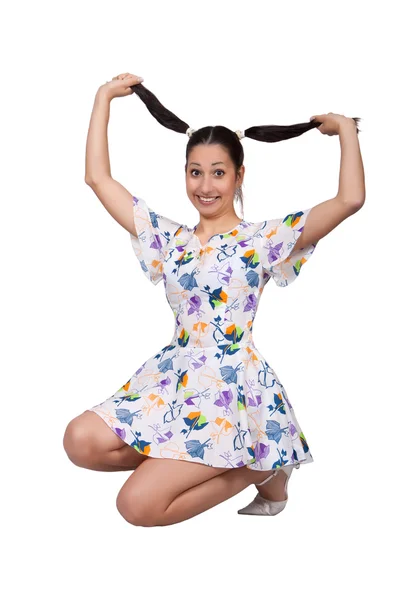 Een meisje met pigtails in kleurrijke retro jurk — Stockfoto