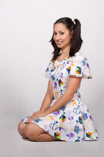 A girl with pigtails in colorful retro dress — Stock Photo, Image