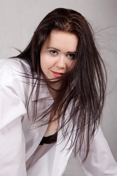 Disheveled long-haired woman in a white men's shirt — Stock Photo, Image