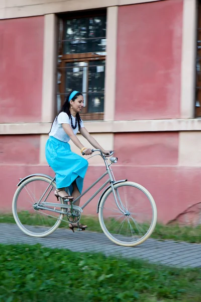 Retro girl on old bike — Stock Photo, Image