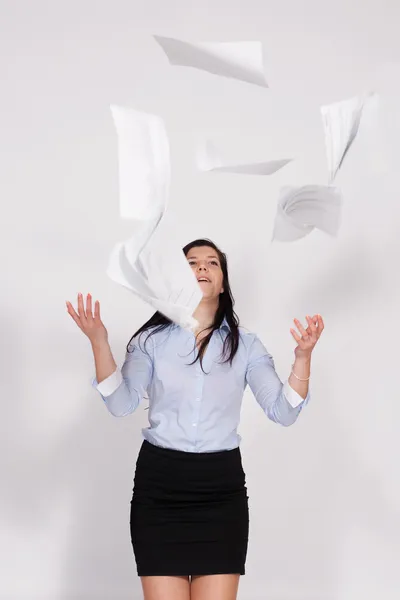 Woman throws out paper into the air — Stock Photo, Image