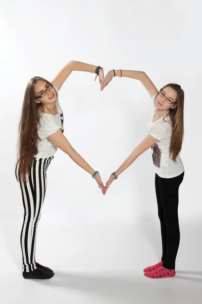 Two sisters and heart — Stock Photo, Image
