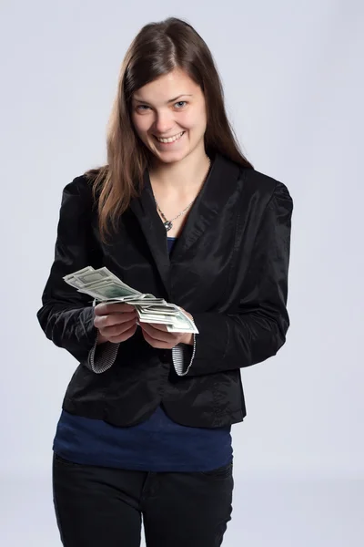 Young long-haired woman holding money — Stock Photo, Image