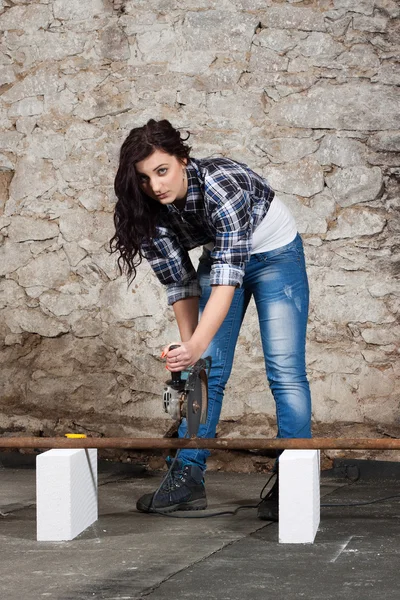 Young long-haired woman with an angle grinder — Stock Photo, Image
