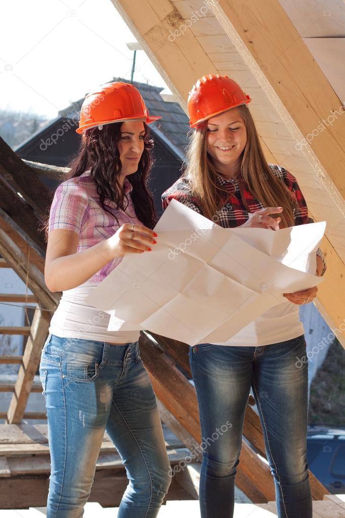 Two young women workers on the roof