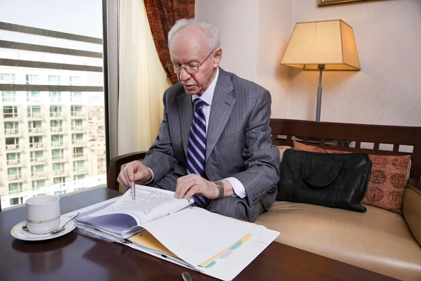 Senior Businessman Going Over Papers — Stock Photo, Image