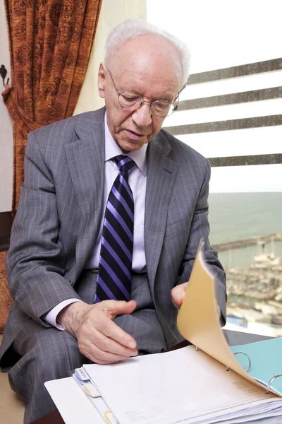 Senior Businessman Going Over Papers — Stock Photo, Image