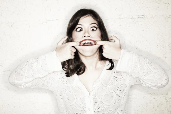 Portrait of a beautiful young woman making a monster face — Stock Photo, Image