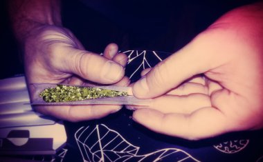 Rolling a Marijuana Joint Lomo Style clipart