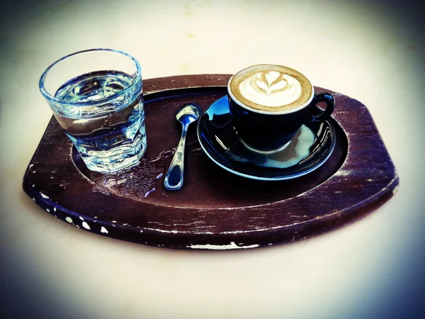 Lomo Cappuccino and Sparkling Water on a Tray — Stock Photo, Image