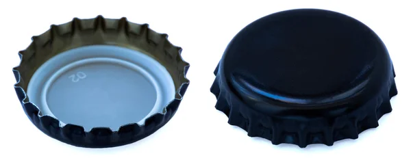 Två vinklar av svart färgade metall cap — Stockfoto