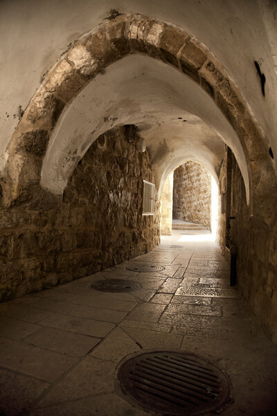 A pedestrian arched tunnel in the Jewish quarter of the old city of Jerusalem, Israel.