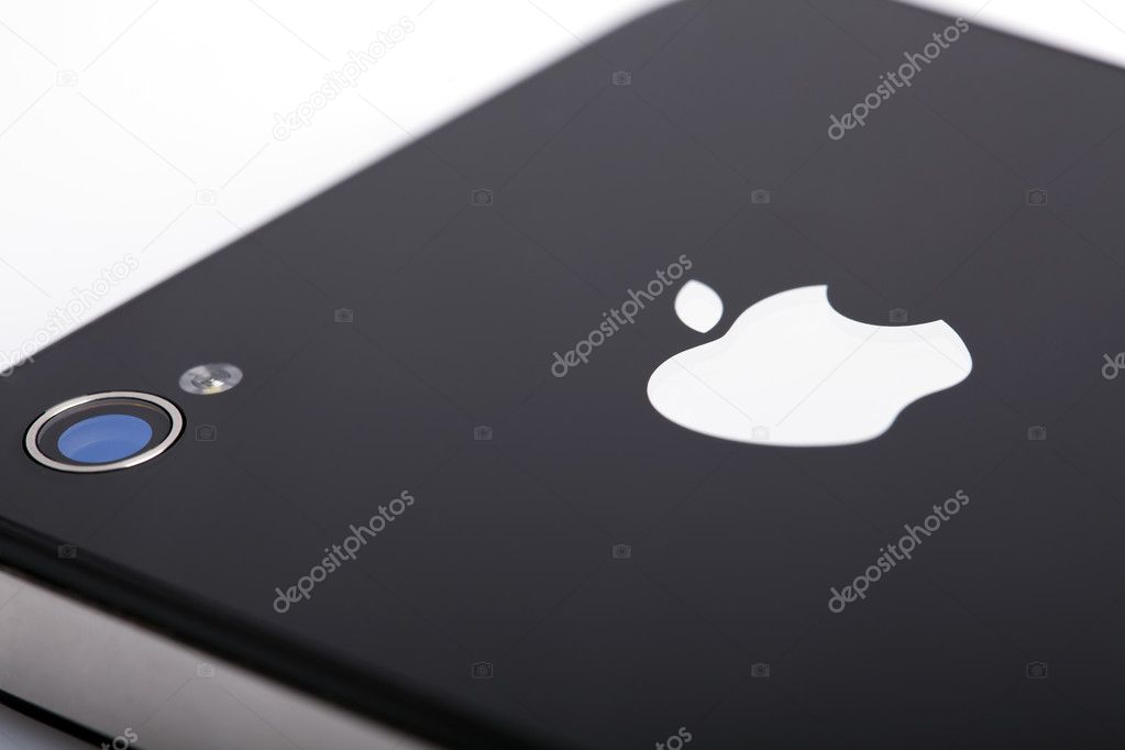Extreme macro image of an iPhone 4 back side, featuring Apple logo and the phone's camera.