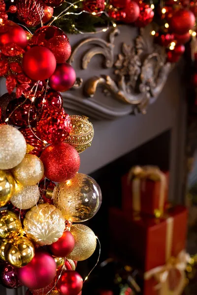 Рождественский камин украшен шариками и огнями в роскошный интерьер крупным планом — стоковое фото