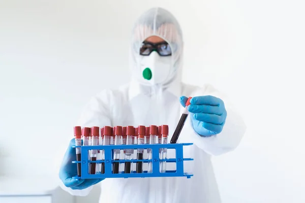 Technician of health with blood tubes in the clinical lab for analytical , Medical, pharmaceutical and scientific research and development concept