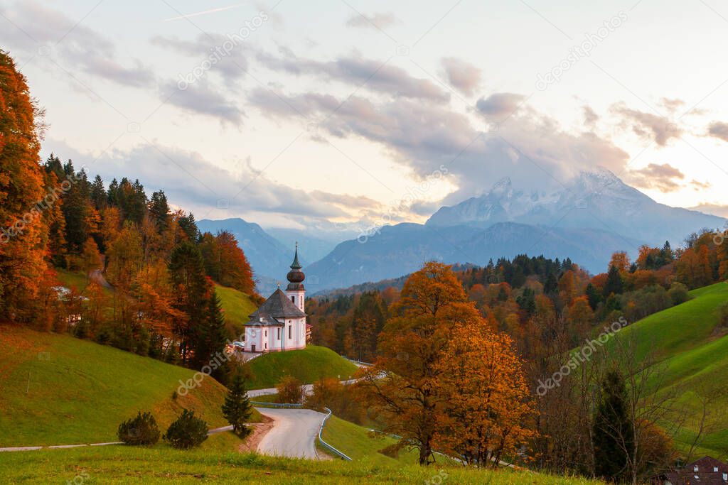 Church of Maria Gern in the mountains in the background with the Watzmann mountain in autumn colors at sunset, Bavaria, Berchtesgaden in Germany