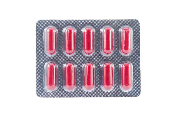 Red capsule in transparent blister pack — Stock Photo, Image