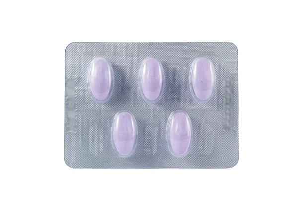 Purple tablet in transparent blister pack — Stock Photo, Image