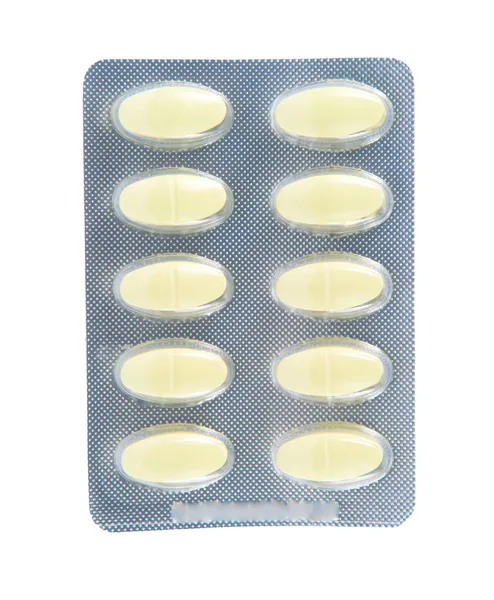Żółte tabletki w przezroczyste opakowanie blister — Zdjęcie stockowe