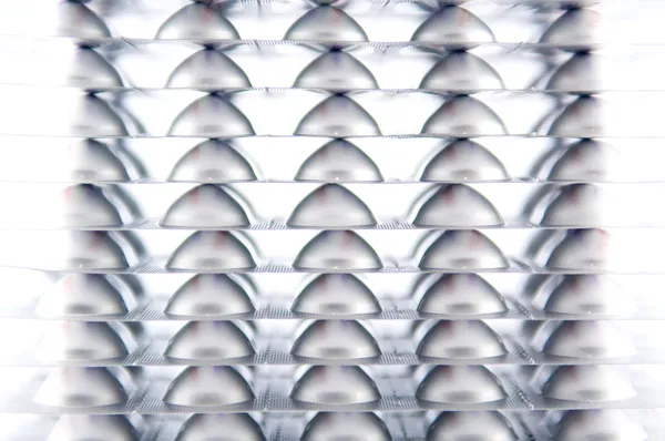 Closed up layer of aluminum blister pack on white — Stock Photo, Image