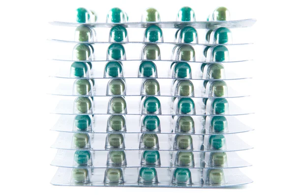 Closed up layer of green capsule in blister pack on white — Stock Photo, Image