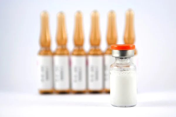 Orange cap injection vials on brown ampule — Stock Photo, Image