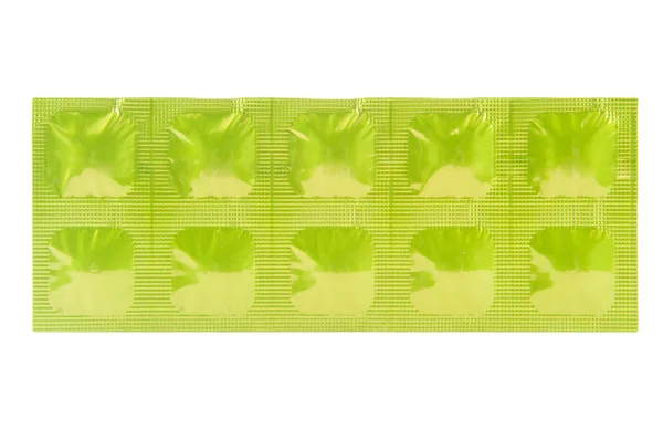 Tablet in green aluminum strip pack — Stock Photo, Image