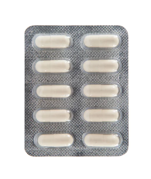 Vit kapsel i transparent blisterförpackning — Stockfoto