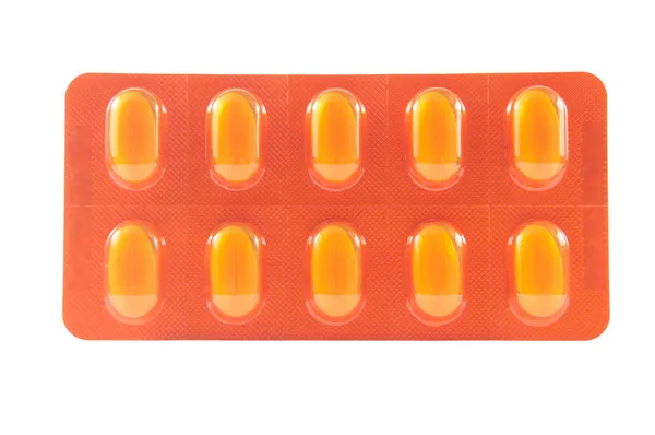 Tablet v žluté průhledné Blistrové balení — Stock fotografie