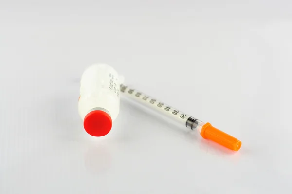 Syringe and insulin vial on white background — Stock Photo, Image