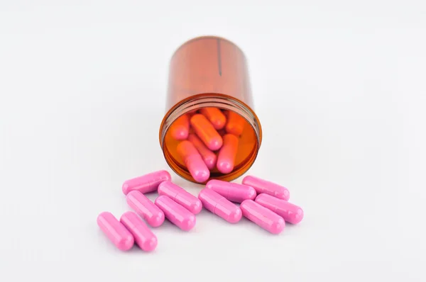 Roze capsule in voorschrift fles — Stockfoto