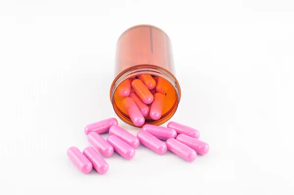 Pink capsule in prescription bottle — Stock Photo, Image