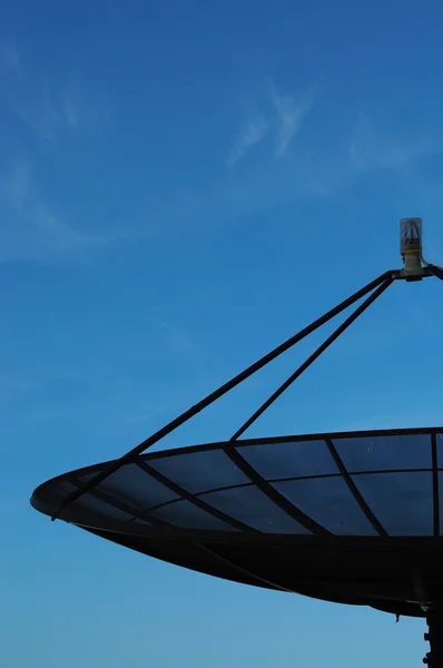 A half of Satellite dish on blue sky blackground — Stock Photo, Image