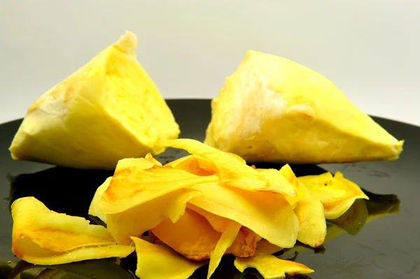 Closed up durian fresh and fried on black dish. — Stock Photo, Image