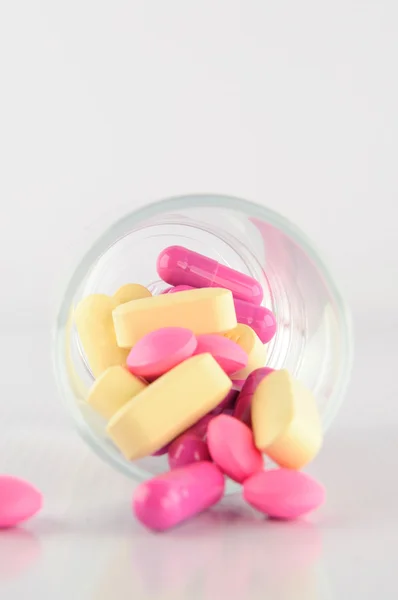 Medicine tablet and capsule in glass — Stock Photo, Image