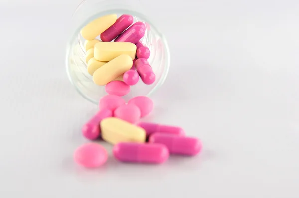 Medicine tablet and capsule in glass — Stock Photo, Image