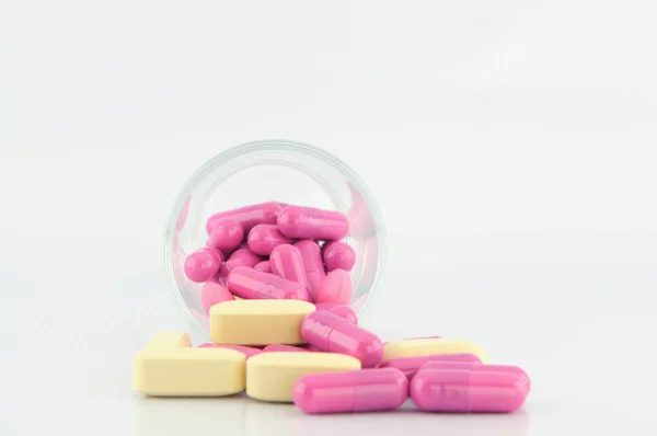 Medicine tablet and capsule in glass — Stock Photo, Image